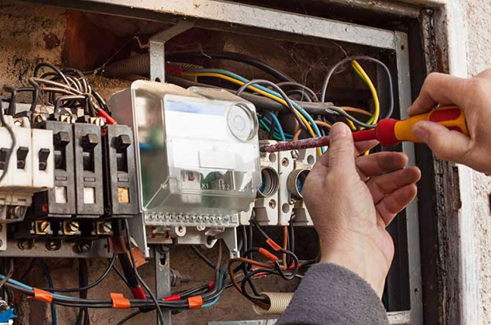 an electrician working on an electrical panel upgrade